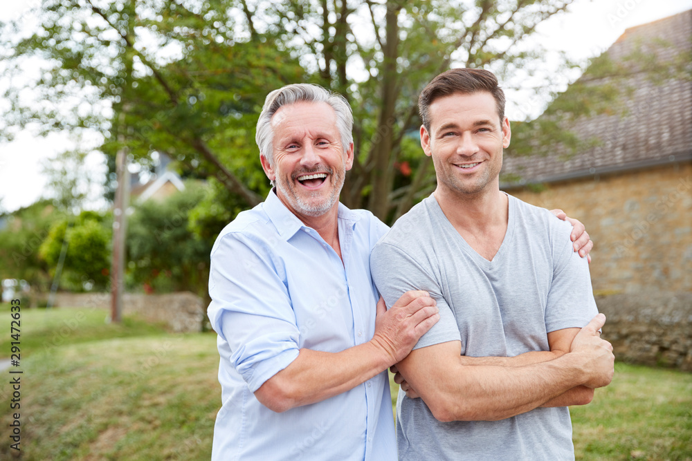 Portrait Of Senior Father With Adult Son Walking Along Country Road Together Portrait Of Senior Father With Adult Son Walking Along Country Road Together