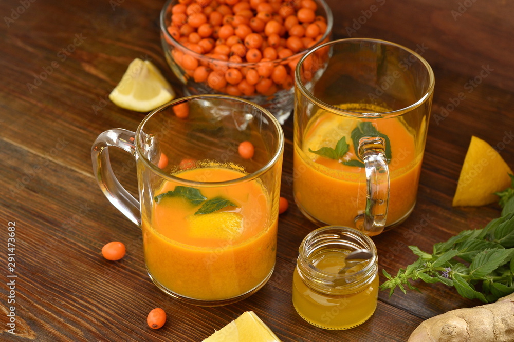 Sea buckthorn tea with lemon, honey and mint, copy space Sea buckthorn tea with lemon, honey and mint, copy space