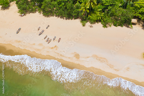 Aerial view of boats moored on the beach, Caribbean beach with waves.