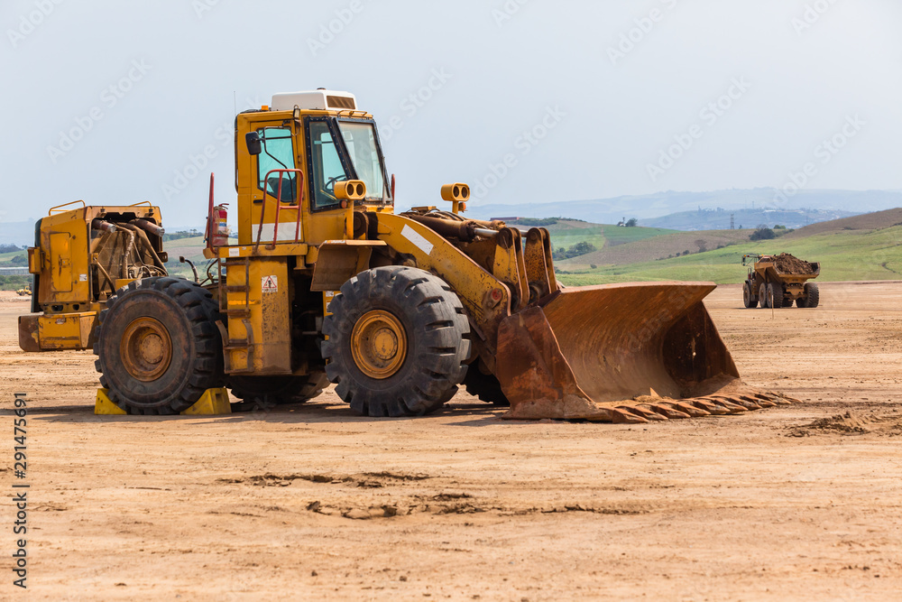 Fototapeta premium Industrial Dump Truck Vehicle Moving Earth Property Development Countryside Landscape.