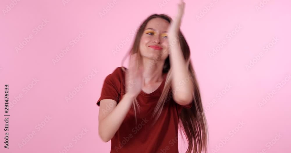Happy teenage girl dancing on pink background Happy teenage girl dancing on pink background