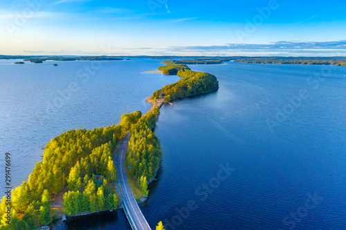Aerial view of Pulkkilanharju Ridge, Paijanne National Park, southern part of Lake Paijanne. Landscape with drone. Blue lakes, road and green forests from above on a sunny summer day in Finland.