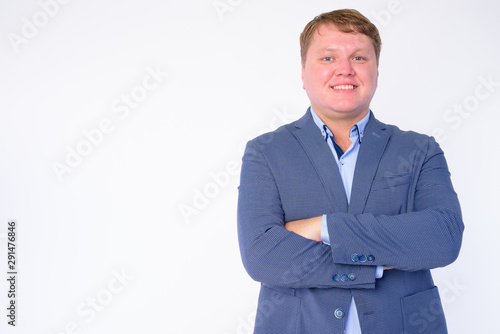 Portrait of happy overweight businessman smiling with arms crossed