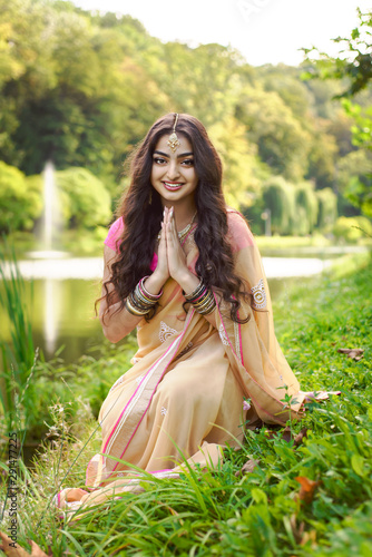 Indian wooman sitting near the river and praying