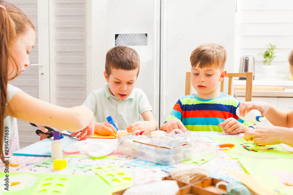 Children do applique work at a workshop