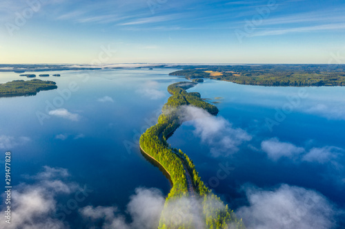 Aerial view of Pulkkilanharju Ridge, Paijanne National Park, southern part of Lake Paijanne. Landscape with drone. Fog, Blue lakes, fields and green forests from above on a sunny summer morning. photo