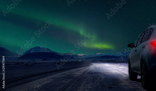 car by night on gravel road of iceland