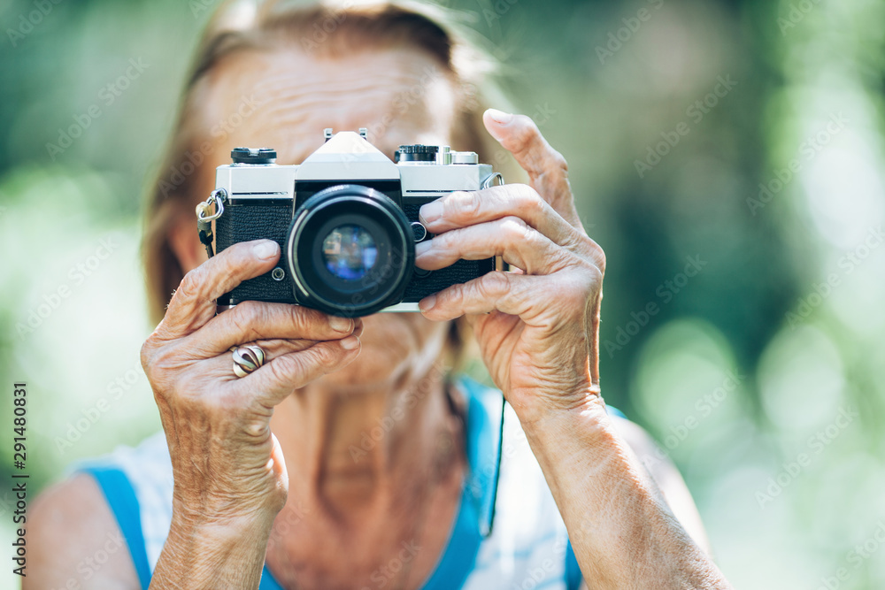 Elderly woman with a photo camera