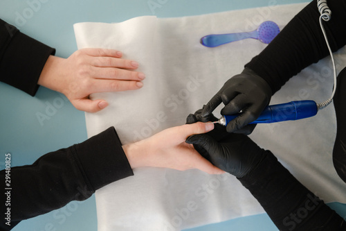 Manicure, cleaning of nails by a milling cutter.