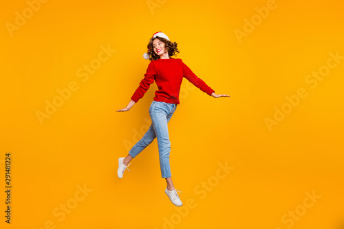 Full body photo of pretty lady jumping high walking down street wear knitted sweater isolated yellow background © deagreez