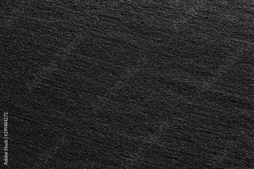 Pattern of black flickering volcanic sand texture