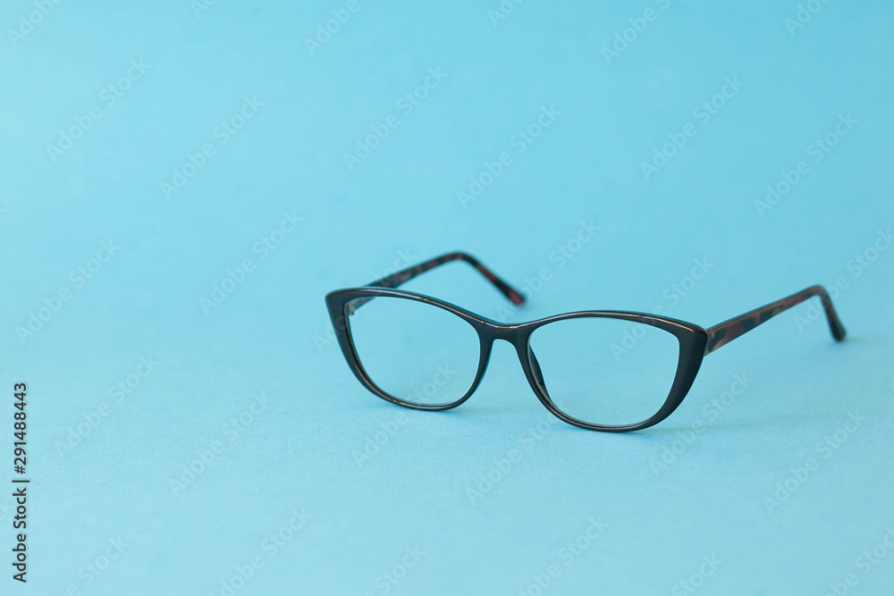 Fashionable stylish glasses on bright background. Optics. Vision.