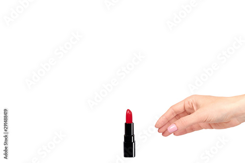Hand with red lipstick in black tube, beauty and care.