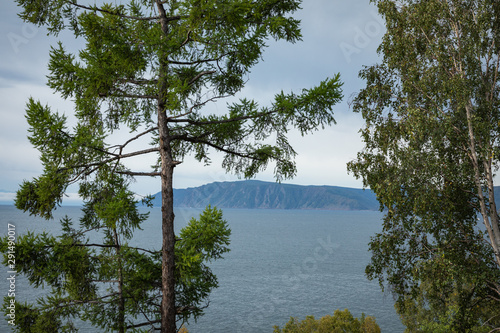 Angara river at lake Baikal in Listvyanka village. Summer landscape on Port Baikal with mountain Chersky stone. Angara River flowing from Lake Baikal, Siberia, Russia photo