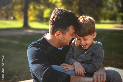 Smiling son having fun with his father