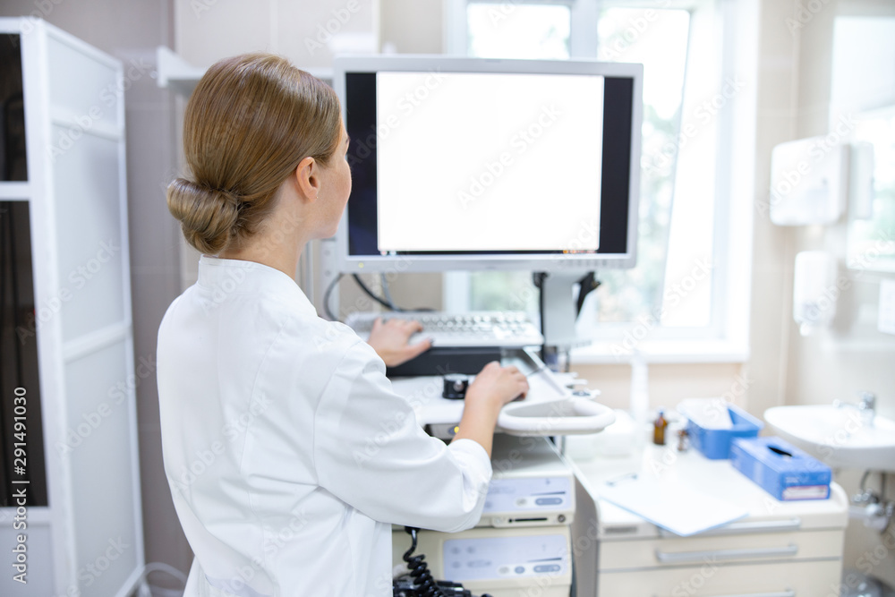 Woman in clinic office with digital equipment stock photo Woman in clinic office with digital equipment stock photo