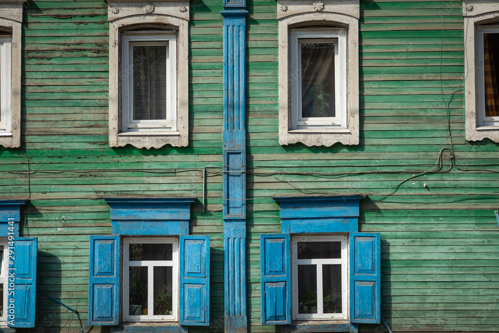 Window with the wooden carved architrave in the old wooden house in the old Russian town. Irkutsk Window with the wooden carved architrave in the old wooden house in the old Russian town. Irkutsk