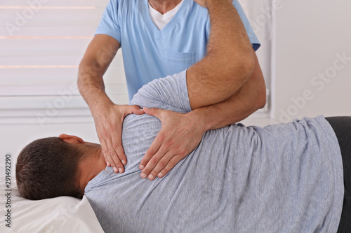 Chiropractic / Osteopathy treatment, Back pain relief. Physiotherapy for male patient, sport injury recovery , Kinesiology