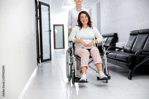 Nurse assisting woman on invalid carrige stock photo photo