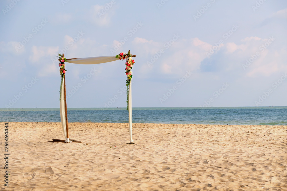 Wedding party site on the beach concept with sea and sand on blue sky day Wedding party site on the beach concept with sea and sand on blue sky day