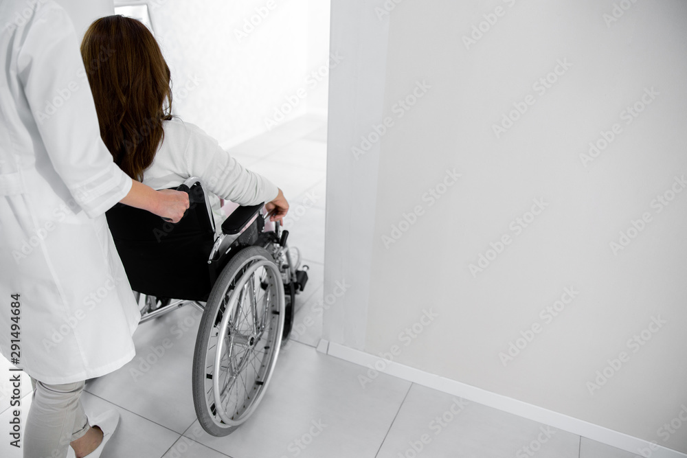 Nurse helping for female patient on wheelchair Nurse helping for female patient on wheelchair