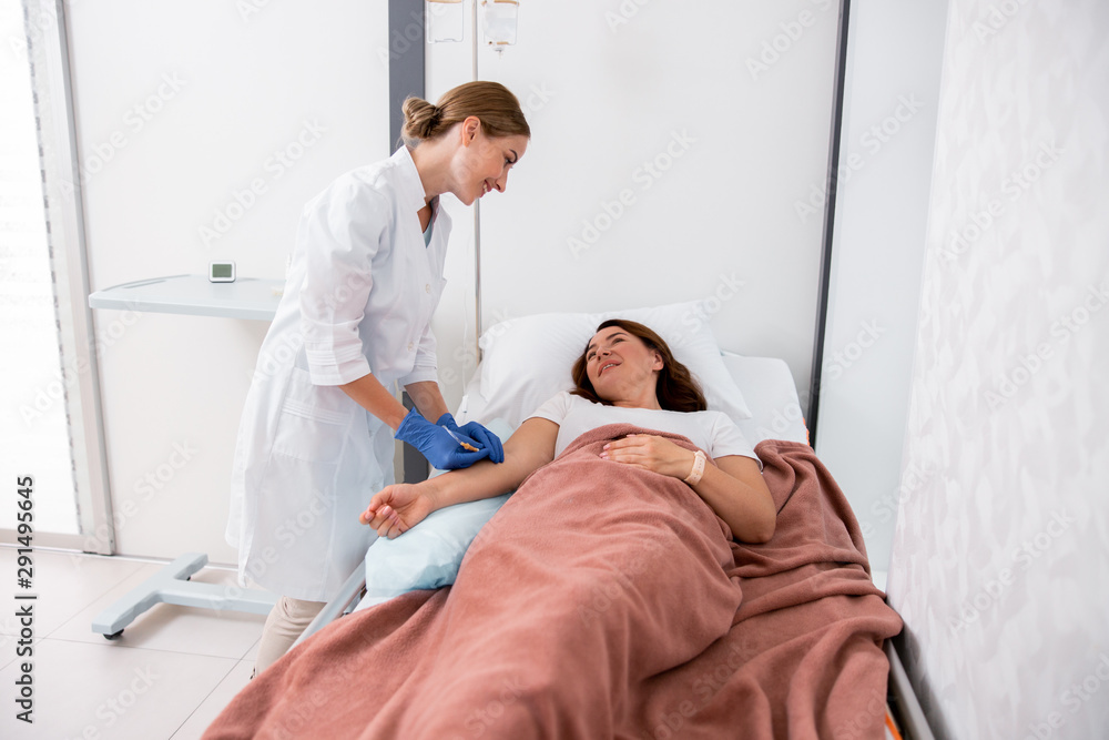 Smiling female doctor is holding dropper for patient Smiling female doctor is holding dropper for patient