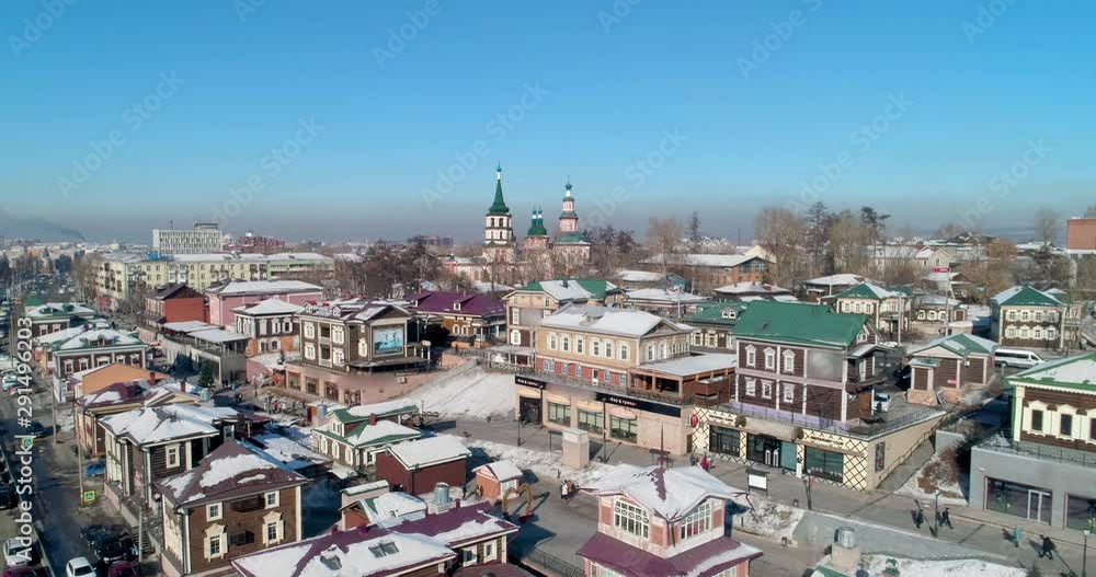 Aerial: Drone reversing on snow covered buildings in city - Irkutsk, Russia Aerial: Drone reversing on snow covered buildings in city - Irkutsk, Russia