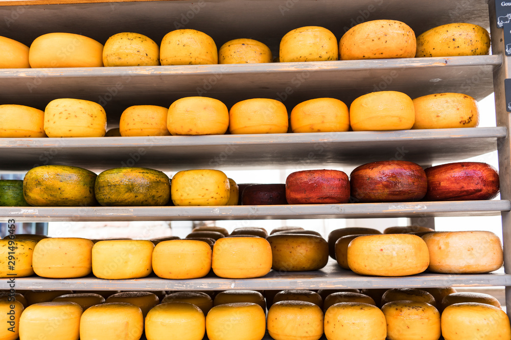 Wheel of Dutch cheese in yellow and red, on shop shelf Wheel of Dutch cheese in yellow and red, on shop shelf
