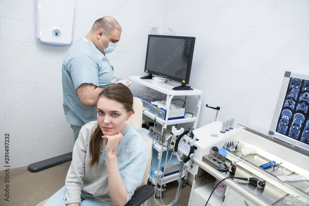 Otolaryngologist examines a young girl