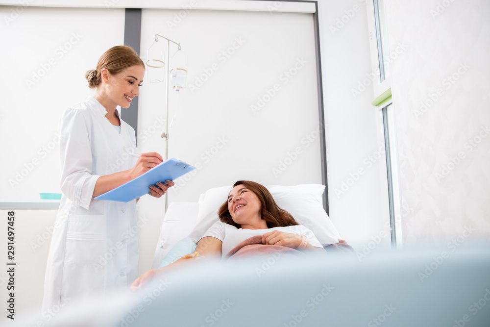 Happy woman is lying in medical center Happy woman is lying in medical center