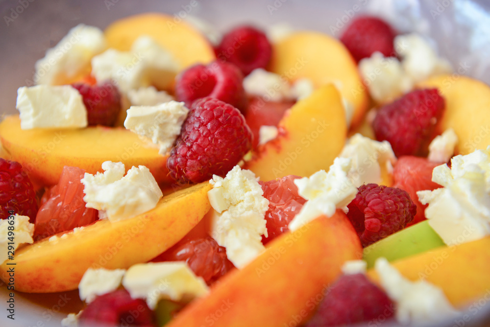 Tasty salad with peach and raspberry, closeup Tasty salad with peach and raspberry, closeup