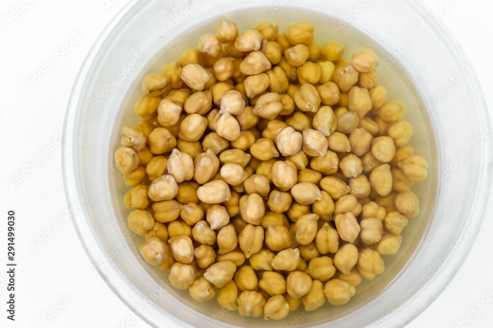 Raw chickpea drenched in water in a transparent bowl, prepared for cooking and future use, concept is healthy eating, horizontal orientation, top view Raw chickpea drenched in water in a transparent bowl, prepared for cooking and future use, concept is healthy eating, horizontal orientation, top view