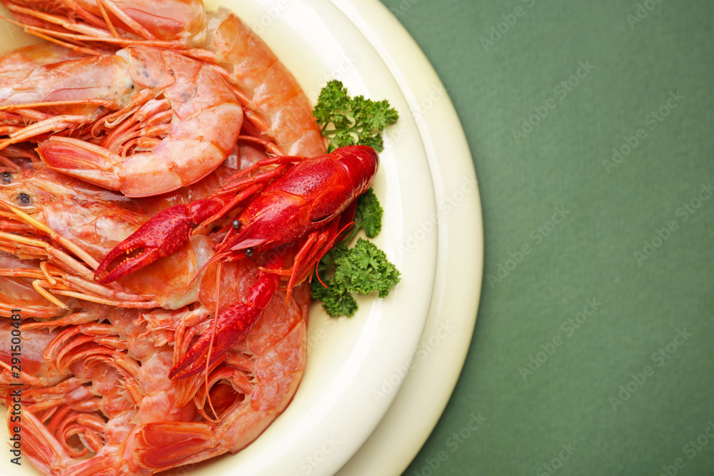 Plate with tasty shrimps and crayfish on color background Plate with tasty shrimps and crayfish on color background