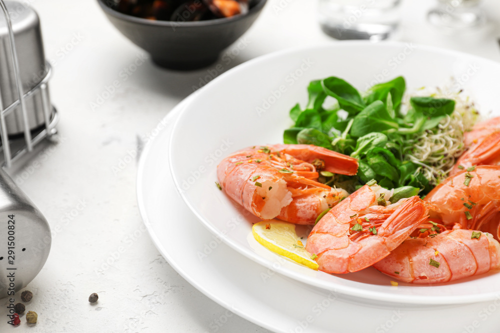 Plate with tasty shrimps on table, closeup Plate with tasty shrimps on table, closeup