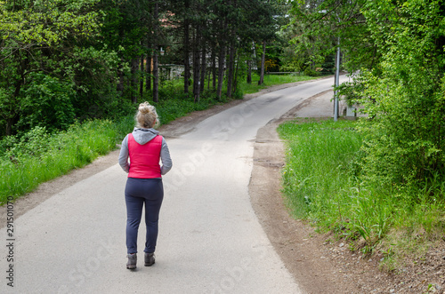 Woman waling through forest