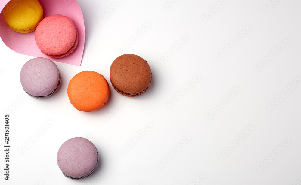 baked macarons in a pink paper bag on a white background baked macarons in a pink paper bag on a white background