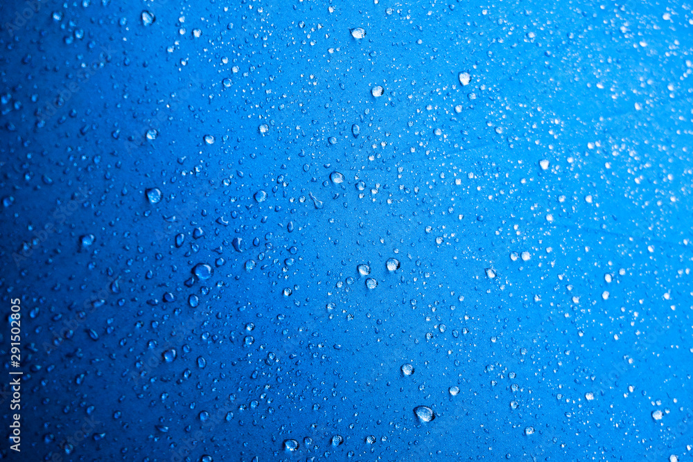 Water drops on the blue fabric.water drops on blue background - obrazy, fototapety, plakaty 