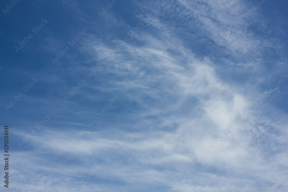 Blue sky with wispy white clouds