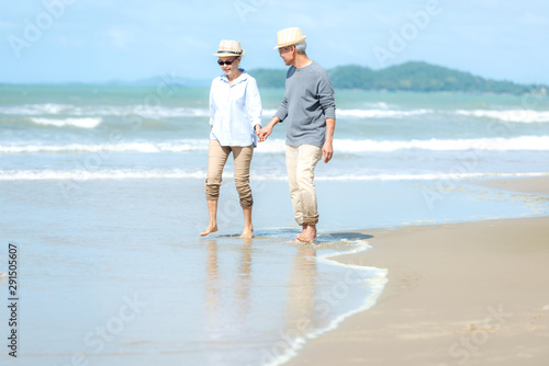 Lifestyle asian senior couple walking happy and relax on the beach. Tourism elderly family travel leisure and activity after retirement vacations and summer.