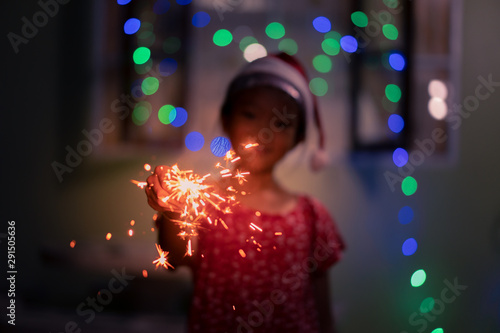 Little girl enjoy playing sparkler celebrate christmas and new year