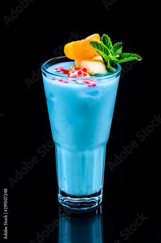 classic blue hawaii cocktail with reflection on dark background