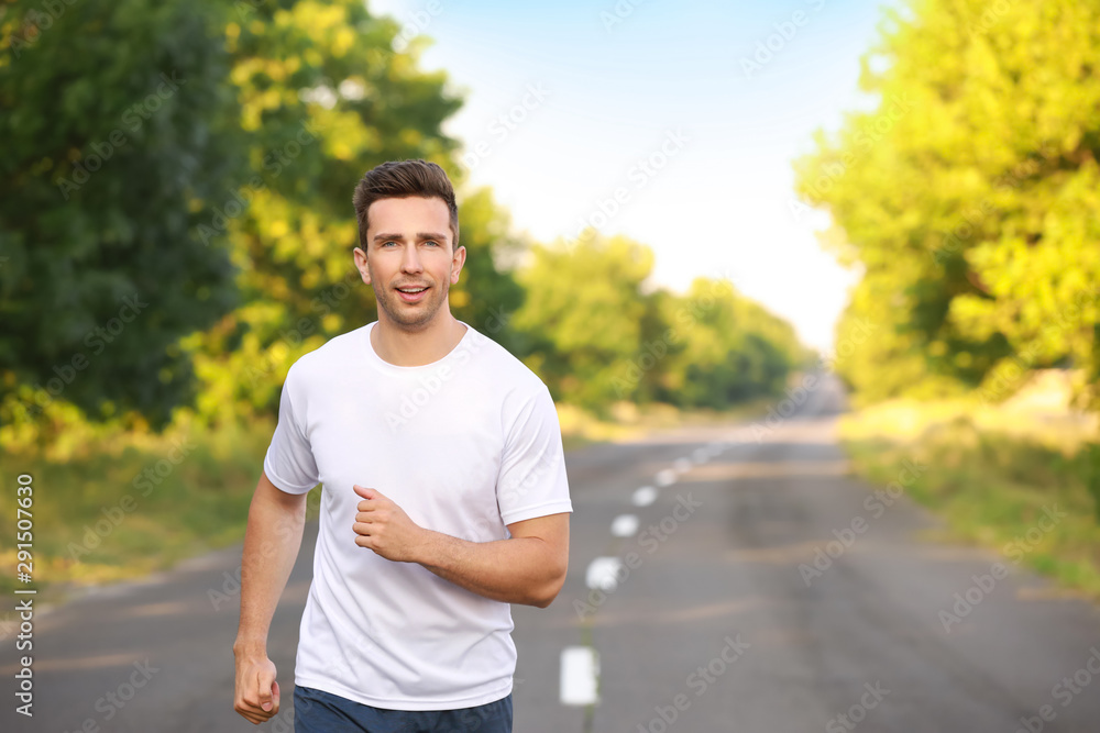 Sporty young man running outdoors