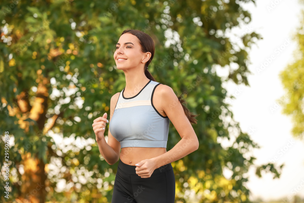 Sporty young woman running outdoors Sporty young woman running outdoors