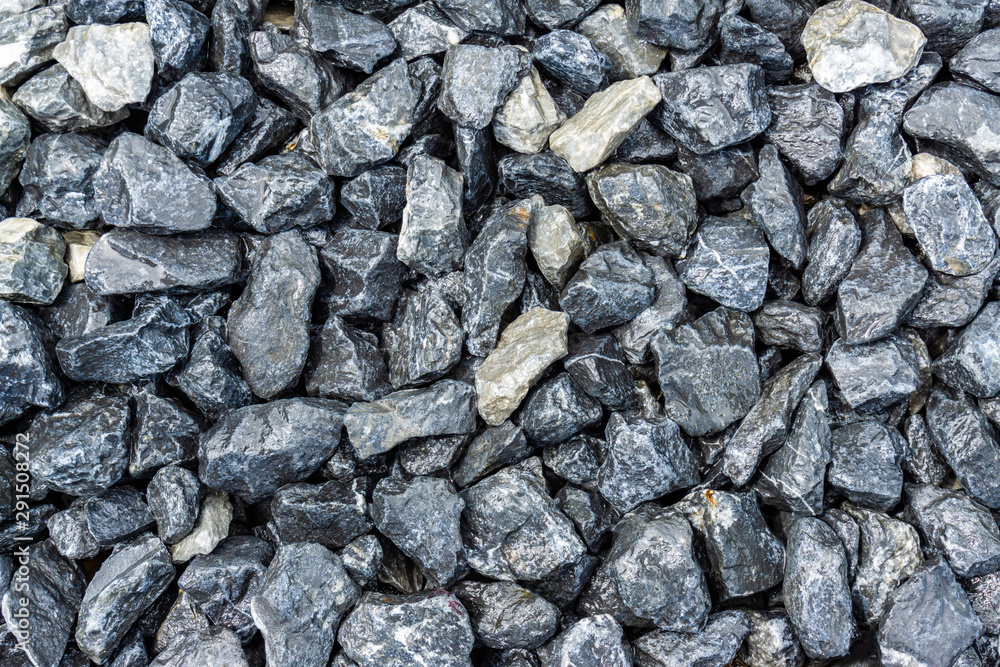 Small rocks or gravel made from stones different shape as stone texture. Used for construction of buildings and roads and as a building material. Small rocks or gravel made from stones different shape as stone texture. Used for construction of buildings and roads and as a building material.