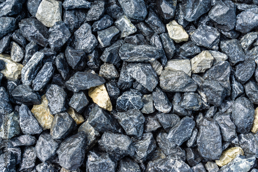 Small rocks or gravel made from stones different shape as stone texture. Used for construction of buildings and roads and as a building material. Small rocks or gravel made from stones different shape as stone texture. Used for construction of buildings and roads and as a building material.