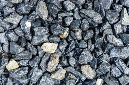 Small rocks or gravel made from stones different shape as stone texture. Used for construction of buildings and roads and as a building material.