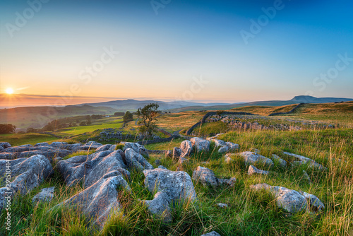Sunset with clear blue skies over a limestone pavement at the Winskill Stones