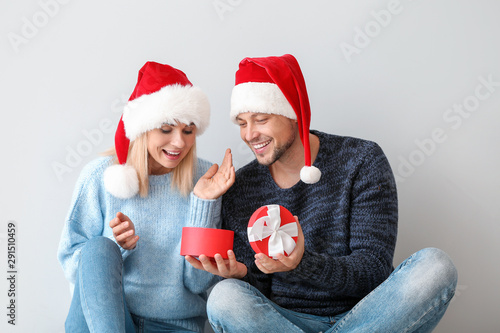 Happy couple in Santa hats ...