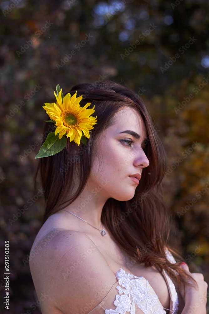 Beautiful cute sexy girl in a white dress with deep neckline with a  sunflower flower in her hair. Enjoying nature. Autumn time. Stock Photo |  Adobe Stock