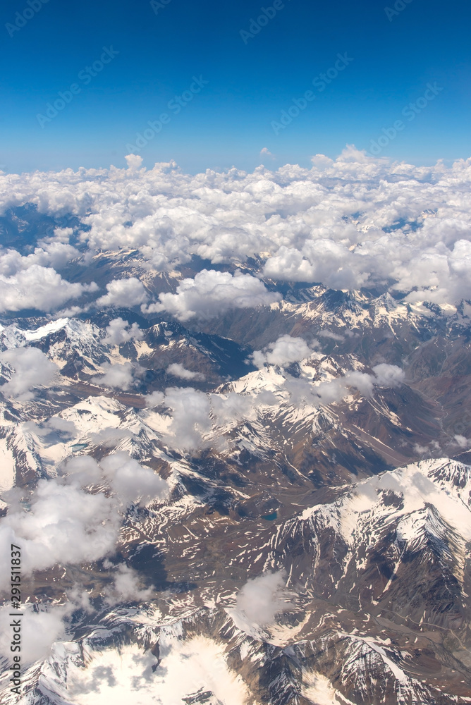 Fototapeta premium Bird eye view of snow mountains and sky cloud from window of airplane at Leh, India